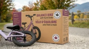 Bilingual Canadian product packaging for a balance bike with hand brake, featuring text in English and French: "Balance Bike / Vélo d'équilibre" with a maple leaf logo.