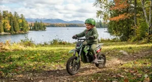 Kid wearing a helmet on an electric dirt bike for outdoor play.