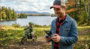 Parent using a remote control for a kids' all-terrain ride-on truck.