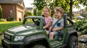 Two children, a girl in a pink shirt and a boy in a striped shirt, smiling and securely fastened in a spacious green two-seater 24V ride-on truck with seatbelts.