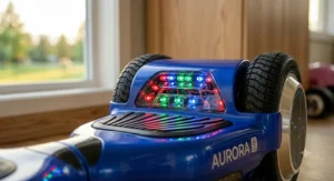 Close-up view of the Aurora hoverboard for kids showcasing brightly illuminated red, green, and blue LED lights on the front bumper and wheel arch.
