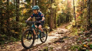An illustration showing essential safety gear, including a helmet and pads, for kids riding bikes aged 8-12.