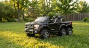 Black battery-powered 2 seater electric ride on kids truck with LED headlights parked on grass