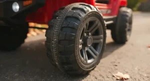 Close-up of durable rubber wheels and dual-motor system on the fastest 24v kids electric car for rugged terrain.