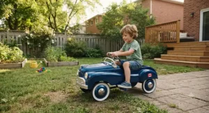 Child playing with a retro metal pedal car outdoors in a suburban backyard