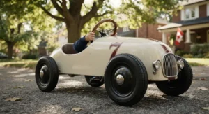 Close-up of a retro-style pedal race car for kids featuring secure rubber wheels and a steering wheel.