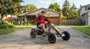 A teenager testing heavy-duty pedal go-karts for backyard racing on a paved driveway in suburban Canada.