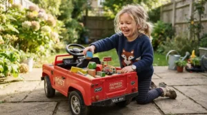 A toddler engaging in pretend play with a cozy coupe with trunk storage in a grassy backyard.