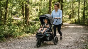 A family walk featuring a push car with canopy for toddlers along a local community nature trail.